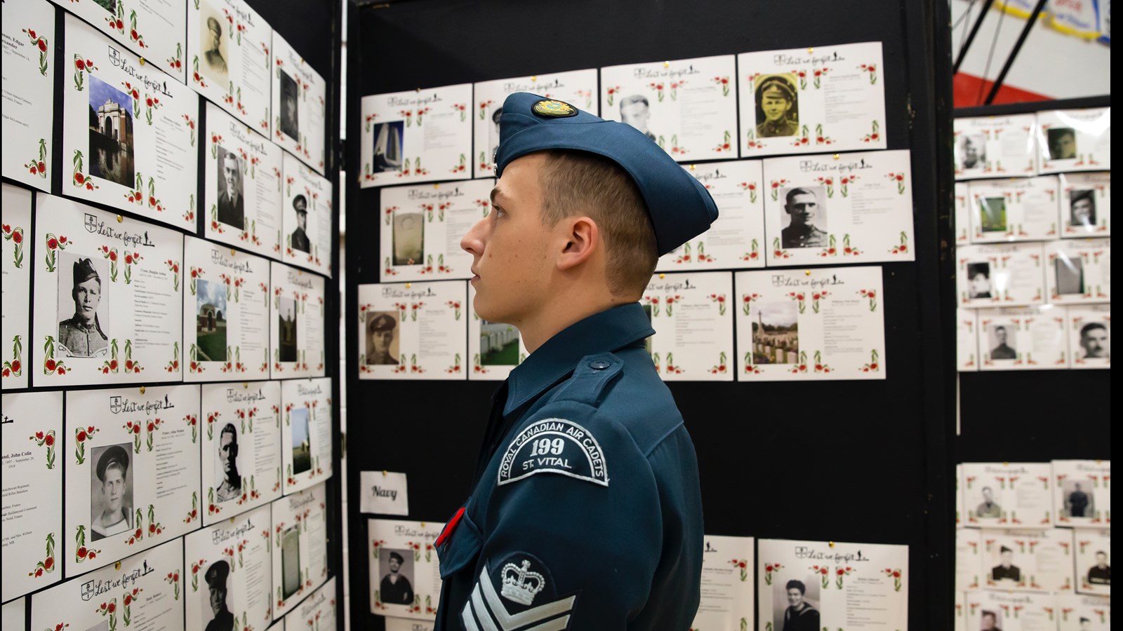 A Kelvin student and air cadet looks at the memorial cards for the school's wartime casualties.